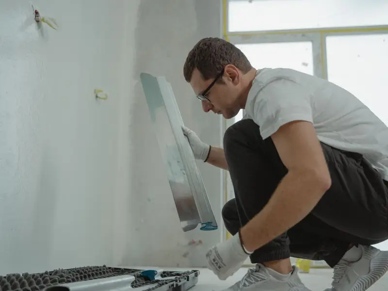 Plasterer finishing a skimmed wall in a Cardiff home